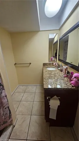 Bathroom with vanity and tile patterned flooring
