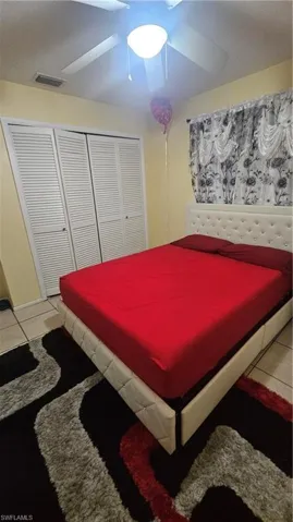 Bedroom featuring a closet, ceiling fan, and tile patterned flooring
