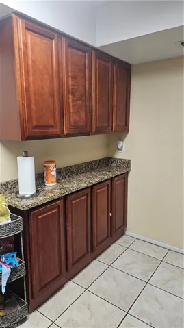Kitchen with dark stone countertops