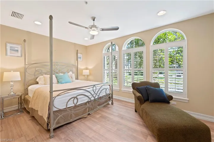 Bedroom featuring light wood-style floors, a ceiling fan, and recessed lighting