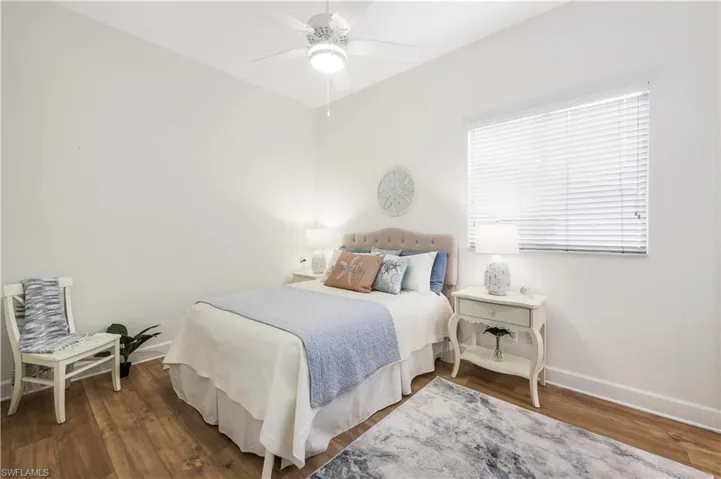 Ensuite guest bedroom featuring ceiling fan, large window and high celings.
