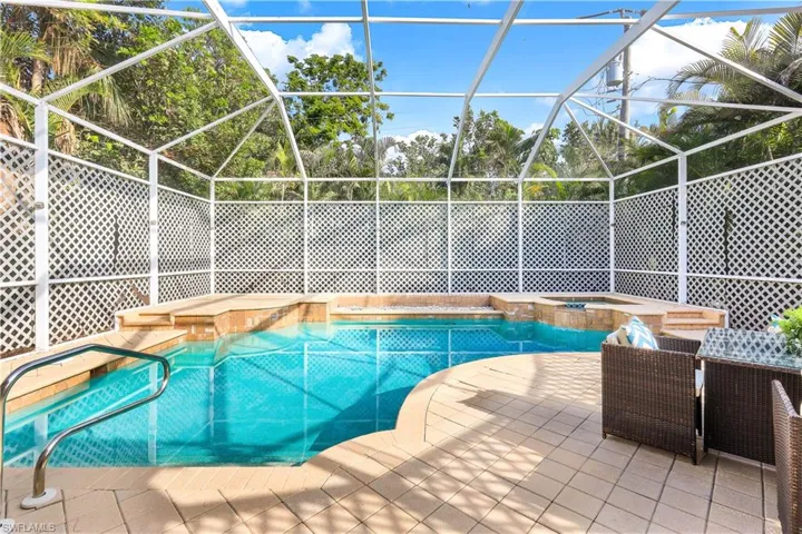 Large private pool and spa with pool cage.