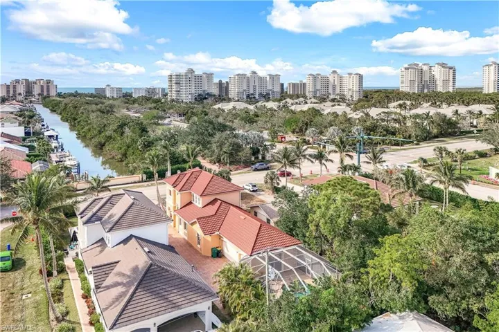 Birds eye view of property with a water view