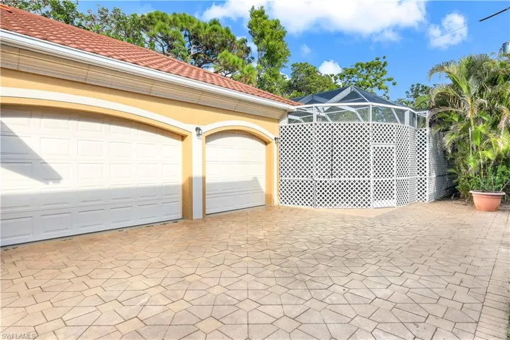 Entrance to two-car garage and one-car garage with long driveway.