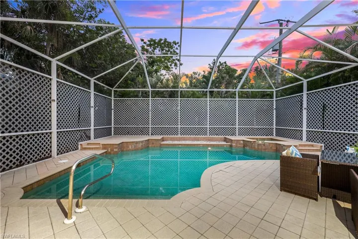 large pool with spa and sitting area.