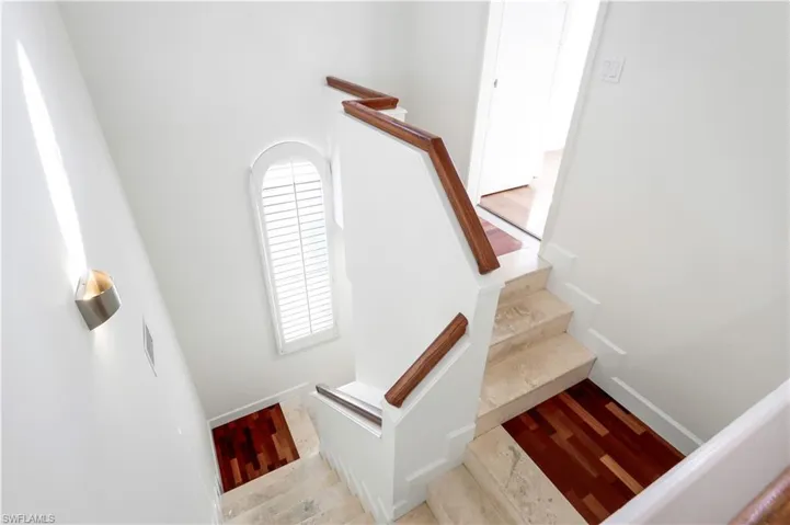 Stairs featuring wood-type flooring