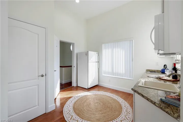Second-floor kitchen with large window and entrance to downstairs.