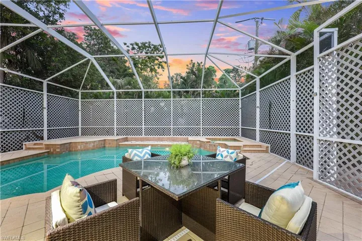 Covered pool and spa with spacious sitting area.