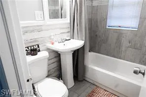 Bathroom featuring shower / bathing tub combination and toilet