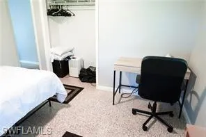 Bedroom with light colored carpet