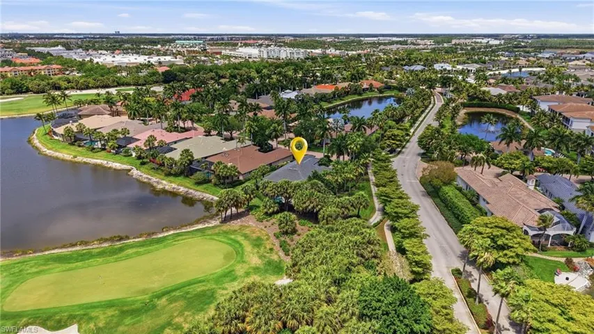 Aerial perspective of a residential property situated on a golf course lot