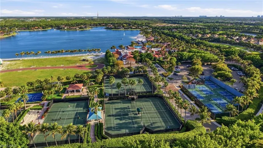 Recreational grounds featuring multiple tennis courts, a basketball court, covered pavilion, and surrounding mature landscaping