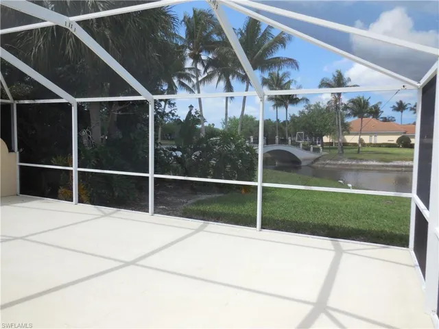 Unfurnished sunroom with a water view and a patio area