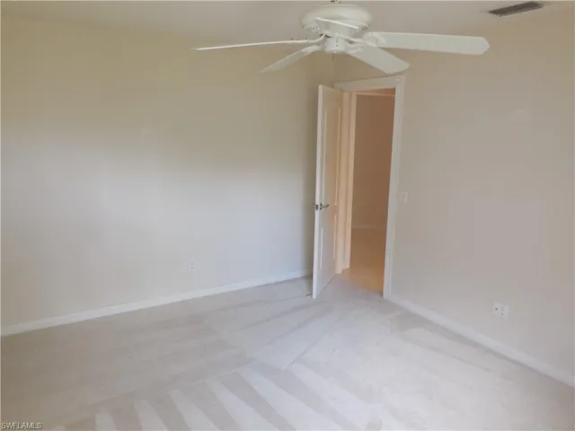 Unfurnished room with light carpet and ceiling fan