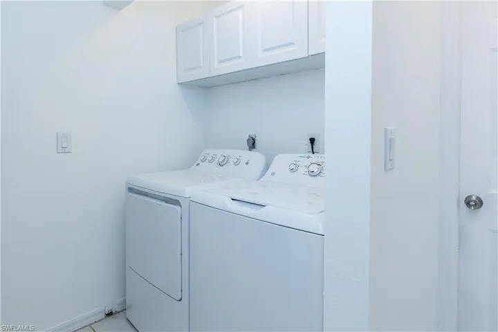 Laundry room with washing machine and dryer and cabinet space