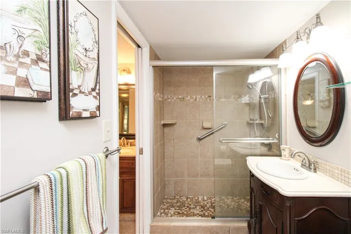 Bathroom featuring a shower stall and vanity