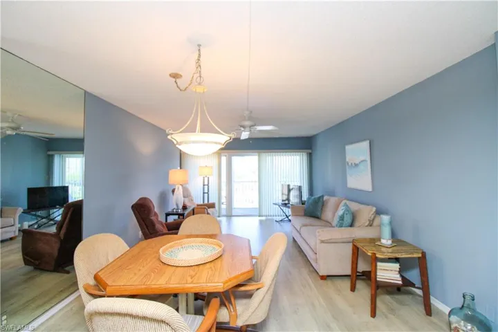 Dining space featuring light wood-style floors, baseboards, and a ceiling fan