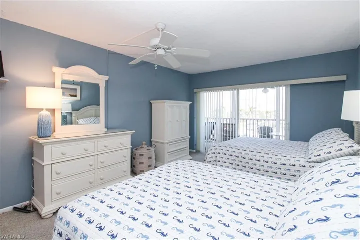 Bedroom featuring access to outside, baseboards, a ceiling fan, and light colored carpet