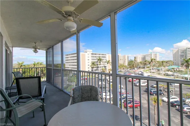 Balcony featuring a view of city and ceiling fan
