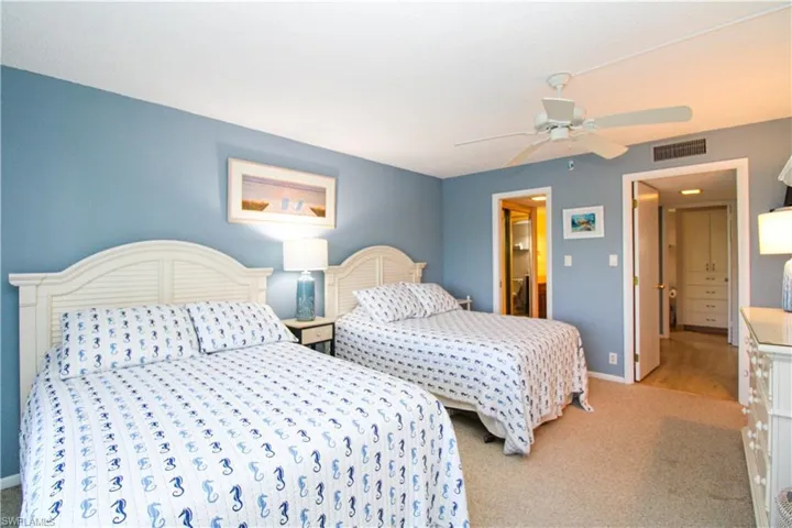 Bedroom featuring ceiling fan, carpet, visible vents, and baseboards