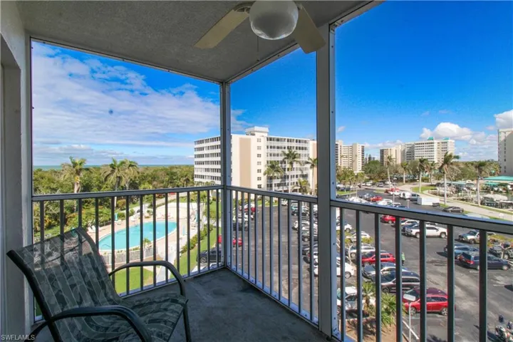 Balcony featuring a view of city and ceiling fan