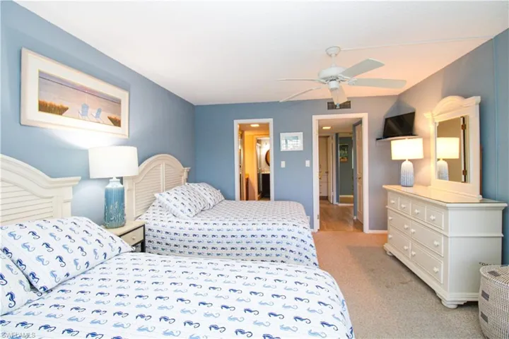 Bedroom with light carpet, visible vents, and a ceiling fan