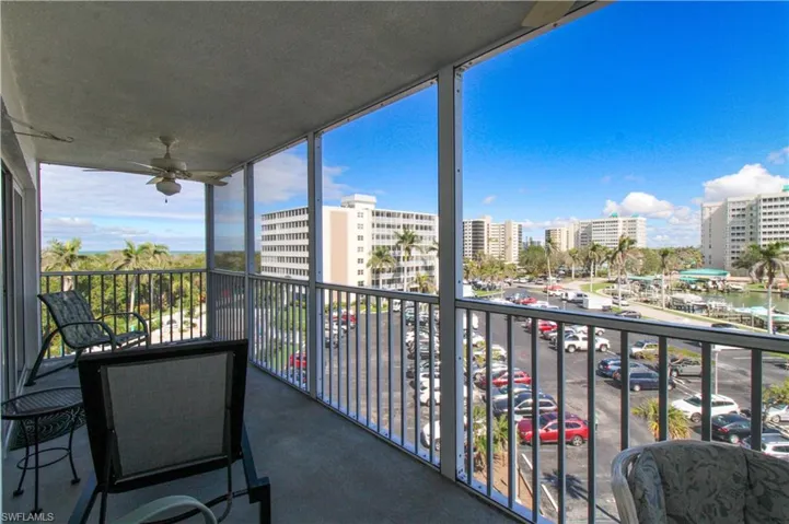 Balcony with ceiling fan and a view of city