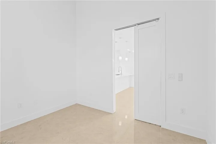 Unfurnished room featuring light tile patterned floors and baseboards