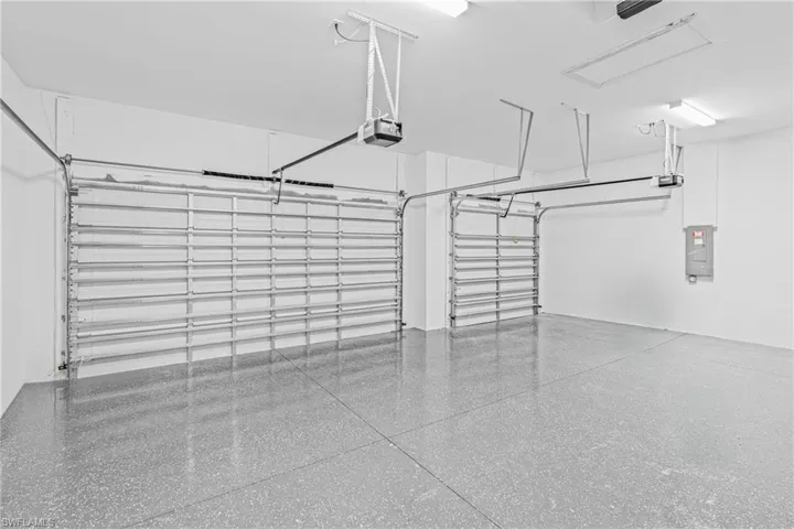 Garage featuring electric panel and a garage door opener