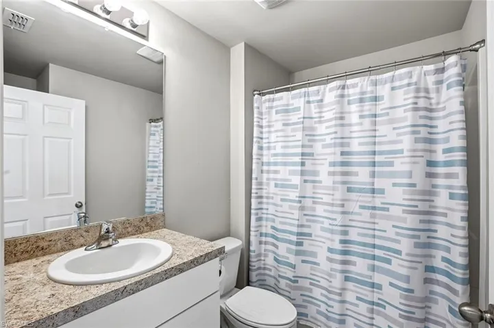 Bathroom with vanity and a shower with shower curtain