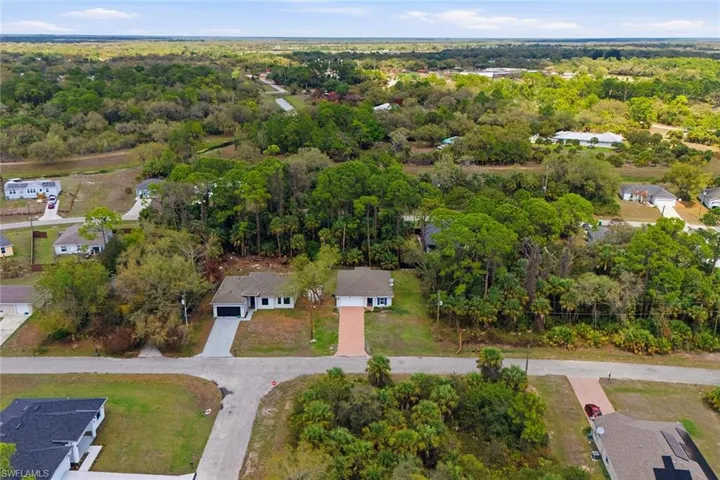 Aerial view of residential area featuring a heavily wooded area