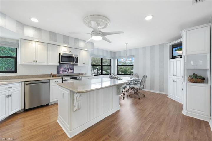 Custom Quartz Counters, White Cabinetry, Breakfast Island