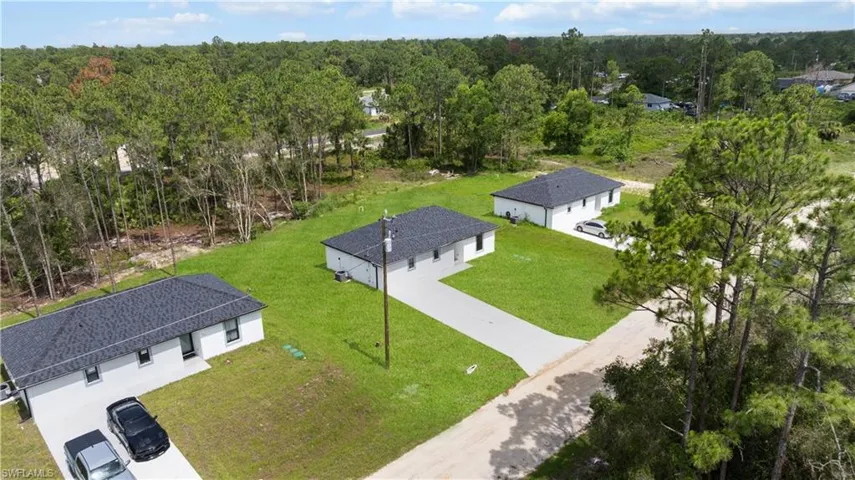 View of subject property with a forest