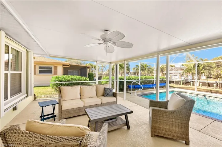 Sunroom featuring plenty of natural light and ceiling fan
