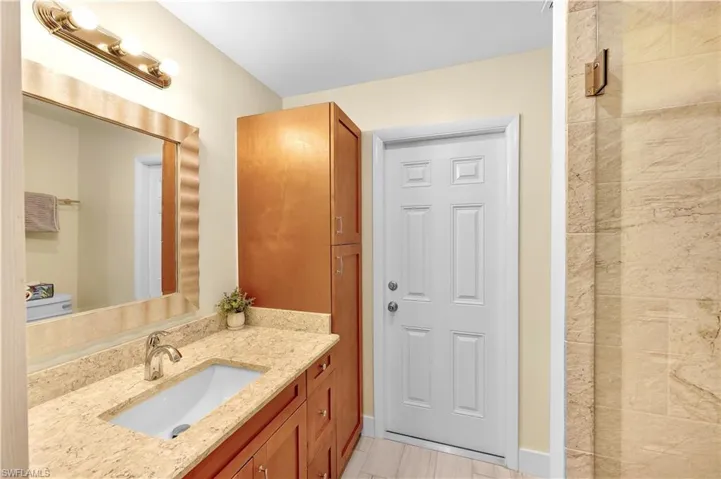 Bathroom featuring tile patterned flooring, vanity, and toilet