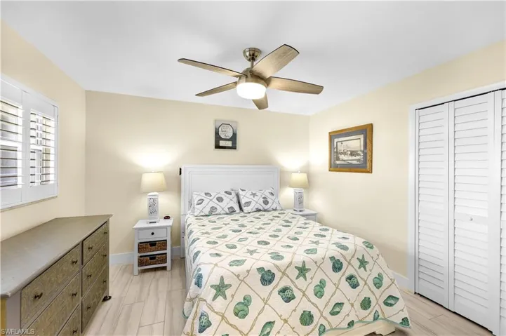 Bedroom with ceiling fan and a closet
