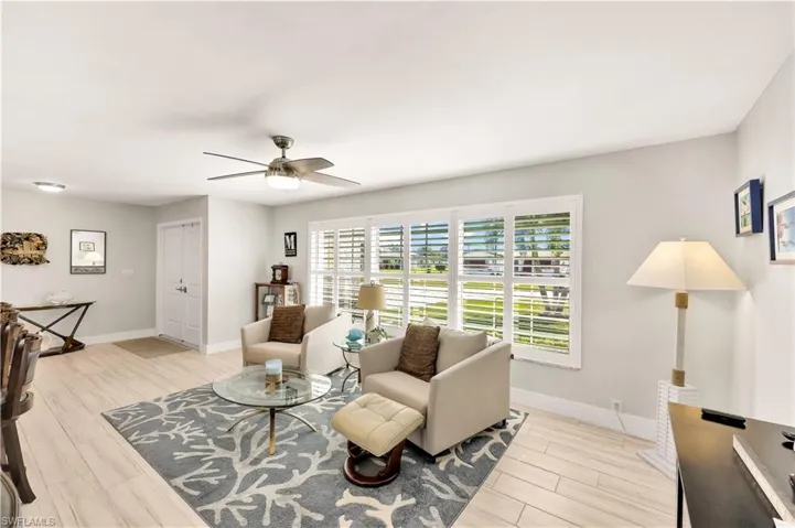 Living room featuring ceiling fan and light hardwood / wood-style flooring