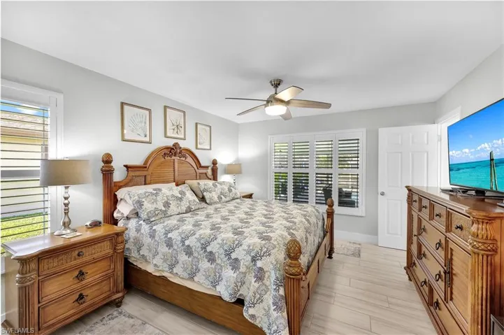 Bedroom with light hardwood / wood-style floors and ceiling fan