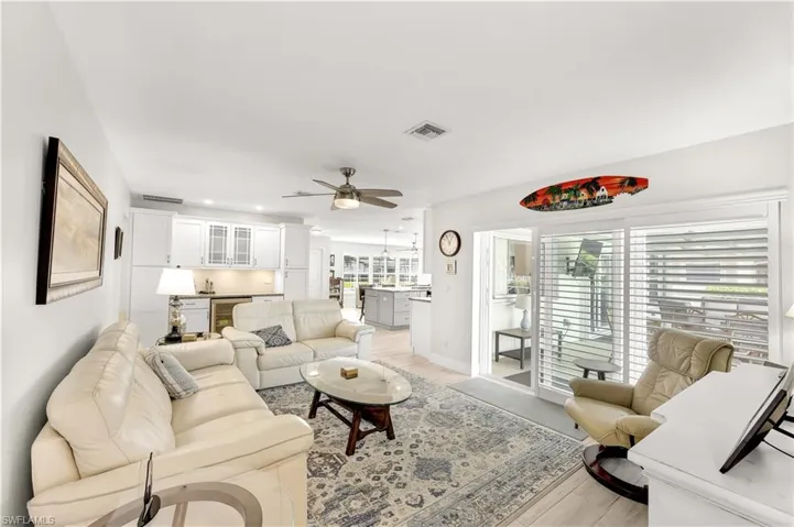 Living room with light hardwood / wood-style flooring and ceiling fan