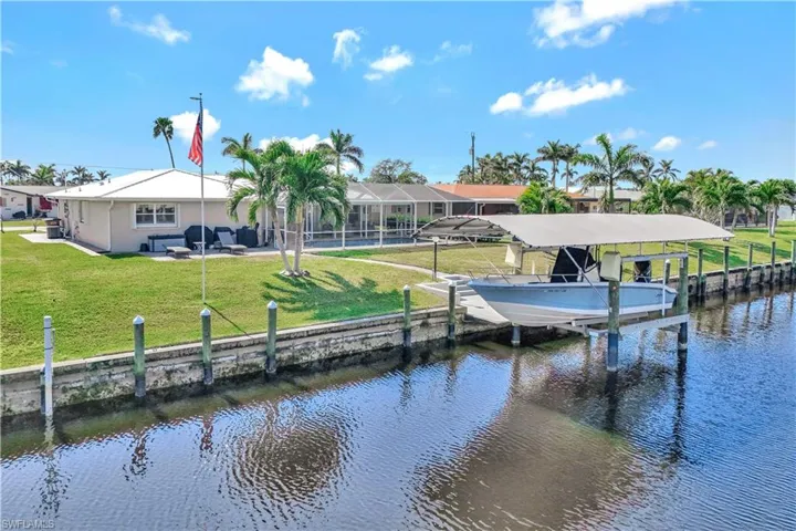 Dock area featuring a lawn and a water view