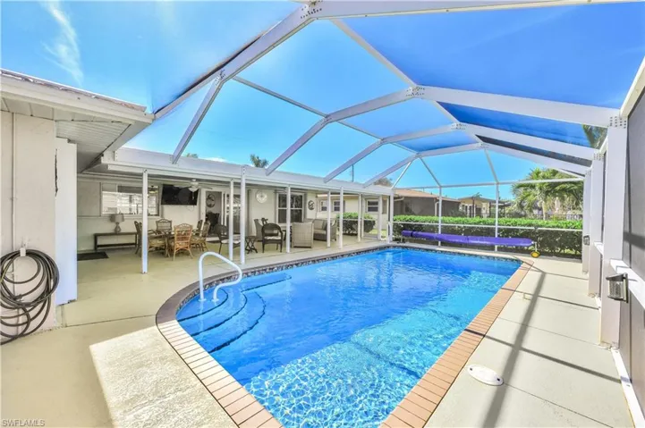 View of swimming pool featuring a lanai, outdoor lounge area, and a patio area
