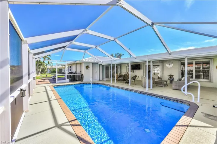 View of swimming pool featuring a patio, a lanai, and an outdoor hangout area