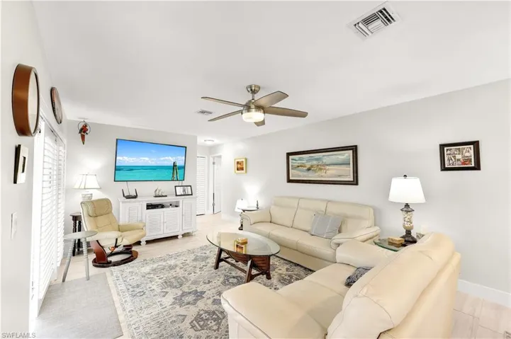 Living room featuring ceiling fan and light hardwood / wood-style flooring