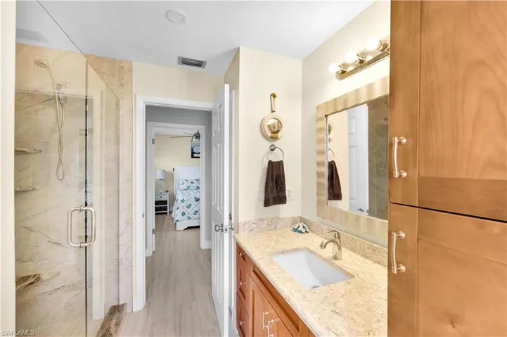 Bathroom featuring vanity and an enclosed shower