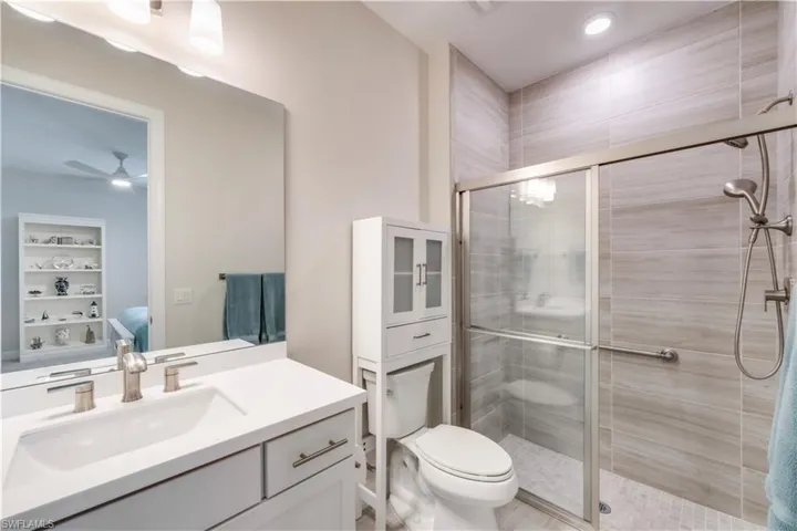 Junior Suite Bathroom featuring walk in glass shower with grab bar