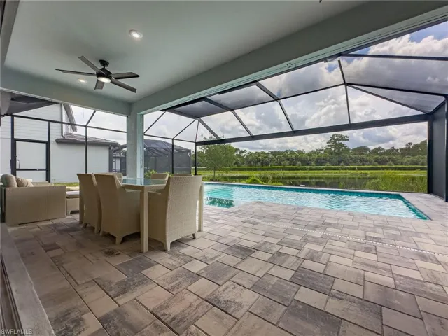 Screened lanai featuring a swimming pool and expansive paver patio