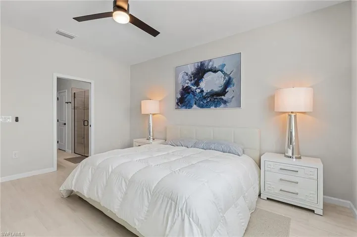 Light-toned wood-finish flooring complements the neutral wall color