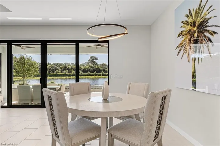 Dining area featuring expansive glass sliding doors opening to an outdoor patio