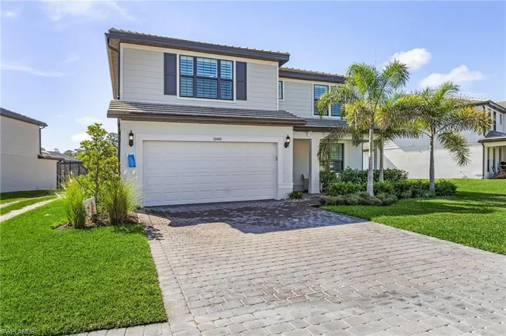 Contemporary two-story residence with a paved driveway and an attached two-car garage