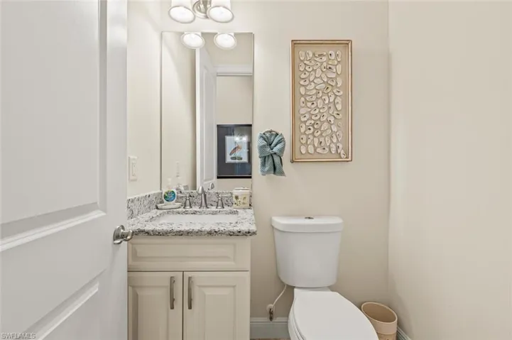 Half bathroom featuring toilet and vanity